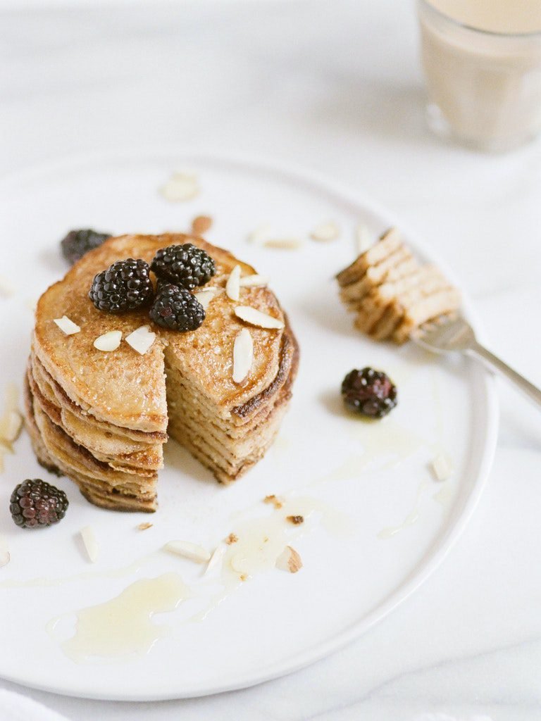 Recipe: Almond Butter Pancakes with Blackberries on a White Plate.